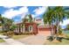 Beautiful two-story home with a paver driveway and well-manicured landscaping at 729 Manns Harbor Drive, Apollo Beach, FL 33572