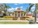 Charming home featuring lush landscaping and a quaint front porch at 729 Manns Harbor Drive, Apollo Beach, FL 33572