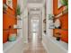 Hallway boasts built-in shelving and direct view to the front door at 729 Manns Harbor Drive, Apollo Beach, FL 33572