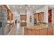 Spacious kitchen featuring granite countertops, wooden cabinetry, and stainless steel appliances at 729 Manns Harbor Drive, Apollo Beach, FL 33572