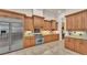 A spacious kitchen features stainless steel appliances, ample wood cabinets, and tile flooring at 729 Manns Harbor Drive, Apollo Beach, FL 33572