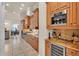 Elegant kitchen featuring custom wood cabinets, granite countertops, and stainless steel appliances at 729 Manns Harbor Drive, Apollo Beach, FL 33572