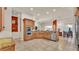 Well-designed kitchen featuring wooden cabinets, stainless steel appliances, and an open layout to the dining area at 729 Manns Harbor Drive, Apollo Beach, FL 33572
