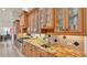 A bright kitchen with stainless steel appliances, granite countertops, and ample cabinet space for storage at 729 Manns Harbor Drive, Apollo Beach, FL 33572