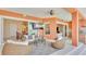 Inviting screened lanai with comfortable seating, outdoor dining, and waterfront views at 729 Manns Harbor Drive, Apollo Beach, FL 33572