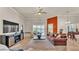 Spacious living room with waterfront view, a leather sofa and ceiling fan at 729 Manns Harbor Drive, Apollo Beach, FL 33572
