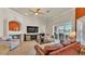 Spacious living room with tile floors, a fireplace, and water views off the lanai at 729 Manns Harbor Drive, Apollo Beach, FL 33572