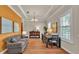 Inviting living room boasts hardwood floors, a neutral color palette, and water views from the window at 729 Manns Harbor Drive, Apollo Beach, FL 33572