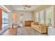 Bright living room with a ceiling fan, sliding doors to the pool, and waterfront views at 729 Manns Harbor Drive, Apollo Beach, FL 33572