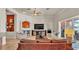 Open living area with fireplace, comfortable seating, and access to the outdoor kitchen at 729 Manns Harbor Drive, Apollo Beach, FL 33572