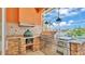 Outdoor kitchen featuring a built-in grill, stainless steel appliances, and counter space at 729 Manns Harbor Drive, Apollo Beach, FL 33572