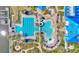 Resort style pool with a slide, palm trees, chairs with umbrellas, a large lap pool and water features at 729 Manns Harbor Drive, Apollo Beach, FL 33572