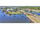 Scenic waterfront view featuring a charming clubhouse and a bridge leading to a beautifully landscaped community at 729 Manns Harbor Drive, Apollo Beach, FL 33572