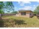 View of home's private backyard with wooden fence at 8184 Rose Ter, Seminole, FL 33777