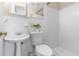 Bright bathroom features a pedestal sink, toilet, shower, and decorative accents at 8184 Rose Ter, Seminole, FL 33777
