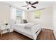Comfortable bedroom with hardwood floors, ceiling fan, and natural light from two windows at 8184 Rose Ter, Seminole, FL 33777
