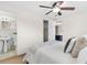 Bedroom featuring hardwood floors, ceiling fan, and a bathroom with a pedestal sink at 8184 Rose Ter, Seminole, FL 33777