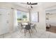Bright dining area with tile floors, natural light, modern chandelier, and view to the bedroom at 8184 Rose Ter, Seminole, FL 33777