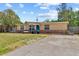 Charming single-story home featuring a brick foundation and a vibrant blue front door at 8184 Rose Ter, Seminole, FL 33777