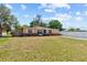 A cozy single-story home with a well-maintained lawn, complemented by a bright blue front door at 8184 Rose Ter, Seminole, FL 33777
