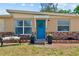 Inviting front entrance with a bright blue door, decorative wreath, and charming brick accents at 8184 Rose Ter, Seminole, FL 33777
