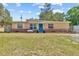 Charming single-story home with a well-maintained lawn, blue front door, and decorative brick accents at 8184 Rose Ter, Seminole, FL 33777
