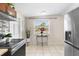 Kitchen featuring stainless appliances, tile flooring, breakfast table and natural light at 8184 Rose Ter, Seminole, FL 33777