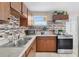 Well-lit kitchen featuring stainless steel appliances, mosaic backsplash and a double sink at 8184 Rose Ter, Seminole, FL 33777