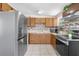 Functional kitchen with stainless steel appliances, tile backsplash, and ample cabinet space at 8184 Rose Ter, Seminole, FL 33777