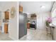 Bright kitchen with tiled floors, stainless steel appliances, and adjacent dining area at 8184 Rose Ter, Seminole, FL 33777