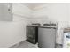 Laundry room with new washer and dryer, utility sink, and wall shelving at 8184 Rose Ter, Seminole, FL 33777