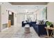 Open-concept living area with tiled flooring, plush seating, and a view of the front entrance at 8184 Rose Ter, Seminole, FL 33777
