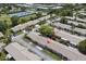 Aerial view of a condo community showcasing well-maintained landscaping and tennis courts at 834 Cambridge Ct, Dunedin, FL 34698