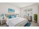 Relaxing bedroom featuring a large bed, tasteful decor, and bedside tables with lamps and a dresser at 834 Cambridge Ct, Dunedin, FL 34698
