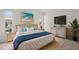 Cozy bedroom featuring large bed, tasteful decor, and bedside tables with lamps and a TV at 834 Cambridge Ct, Dunedin, FL 34698