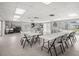 Well-lit clubhouse space with tables, chairs, large windows, and ample space for activities and gatherings at 834 Cambridge Ct, Dunedin, FL 34698