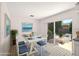 Bright dining room adjacent to the kitchen featuring a large window and slider access to outdoor living space at 834 Cambridge Ct, Dunedin, FL 34698