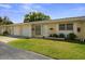 Charming single-story home with a well-maintained lawn and attached one car garage at 834 Cambridge Ct, Dunedin, FL 34698