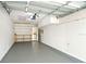Spacious garage with shelving, storage cabinets and epoxy flooring at 834 Cambridge Ct, Dunedin, FL 34698