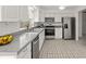 Well-lit kitchen featuring stainless steel appliances and tile flooring at 834 Cambridge Ct, Dunedin, FL 34698