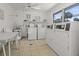 Bright laundry room featuring multiple washers and dryers for resident's convenience at 834 Cambridge Ct, Dunedin, FL 34698