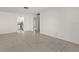 Open living room with tile floors, offering seamless access to other areas of the house at 834 Cambridge Ct, Dunedin, FL 34698