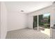Bright living room with tile flooring and sliding glass door to the backyard at 834 Cambridge Ct, Dunedin, FL 34698