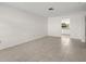Spacious living room with neutral tile flooring and plenty of natural light at 834 Cambridge Ct, Dunedin, FL 34698