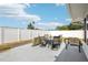 Backyard patio features an outdoor table and chair set with a white fence at 8413 Moulton Dr, Port Richey, FL 34668