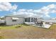 Backyard view with a patio, outdoor table, chairs, and a grill at 8413 Moulton Dr, Port Richey, FL 34668