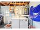 Utility basement features a water heater, washer, dryer, and utility sink at 8413 Moulton Dr, Port Richey, FL 34668