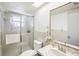 Bathroom features a glass shower door with a Heron design and a framed vanity mirror at 8413 Moulton Dr, Port Richey, FL 34668