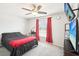 This bedroom has a bed, a desk, a TV, and a window with curtains at 8413 Moulton Dr, Port Richey, FL 34668
