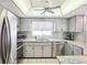 Bright kitchen with stainless appliances, granite counters, and modern lighting at 8413 Moulton Dr, Port Richey, FL 34668